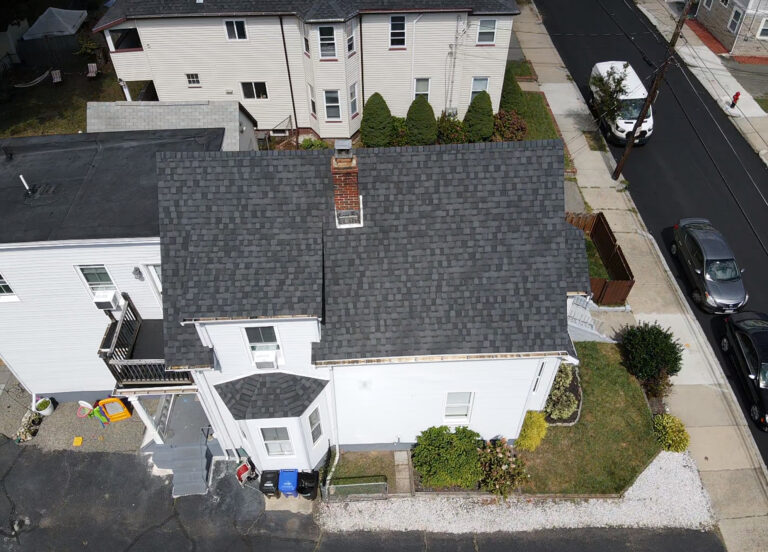 Drone roof inspection photo of an asphalt shingle roof and chimney on a residential home in Boston, MA.