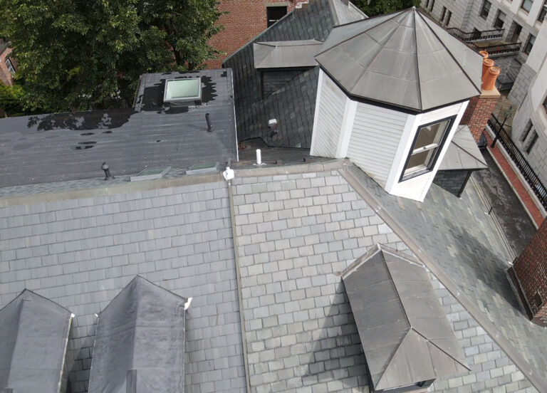 Drone roof inspection photo of a slate roof with skylight and flat roof section on a home in Boston, MA.