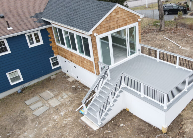Home exterior renovation with new siding and porch stairs in Boston, MA.