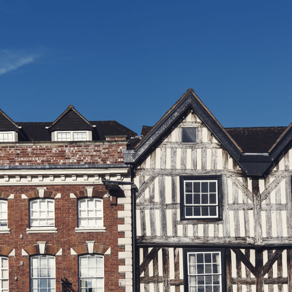 Traditional home rooftops showing different roofing materials and illustrating how long a roof lasts over time
