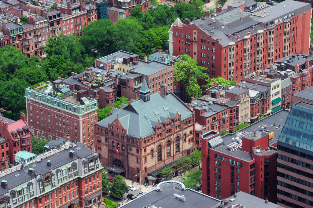 Aerial view of urban buildings  in Boston showcasing different roof types and roofing materials across residential structures