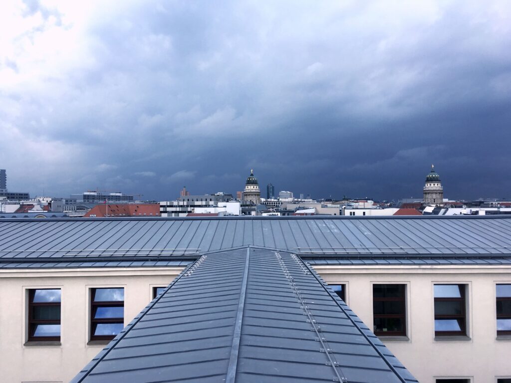 Standing seam metal roof on city building, highlighting durable roofing materials and modern roof types