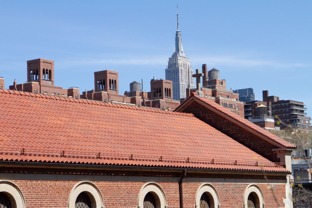 Clay tile roof on urban building, showing durable roofing materials and a roof lasts over time