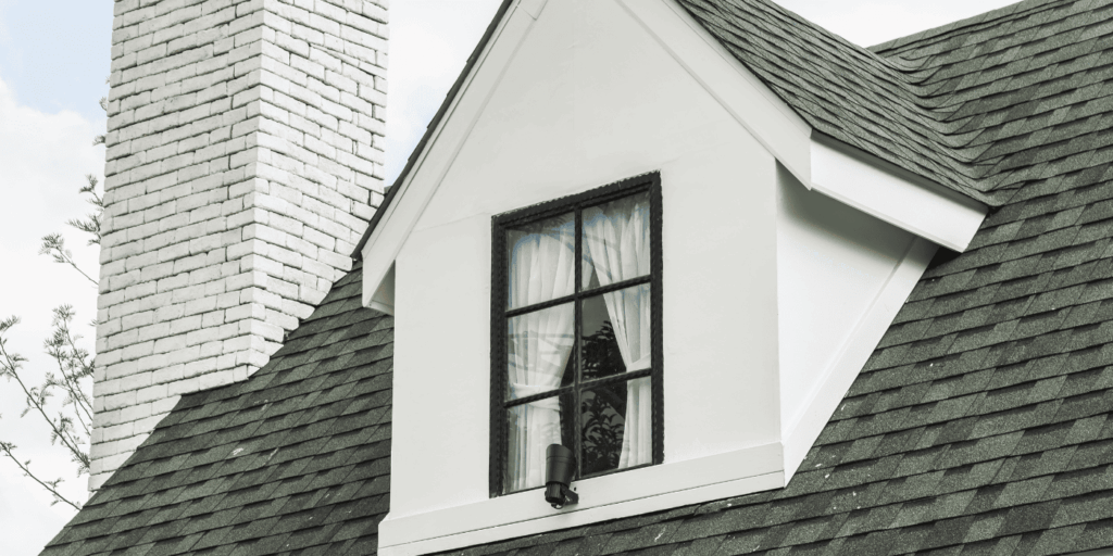 Beautiful home with asphalt shingle roof and dormer window after complete roof rejuvenation service