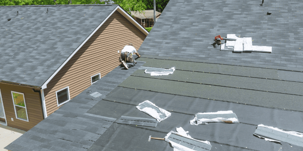 Roofer installing new shingles on a sloped roof, following 4 balls rule roofing best practices