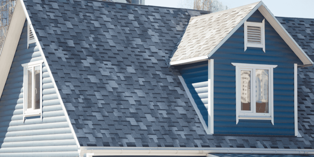 Blue home exterior featuring a durable architectural shingle roof with modern layered design