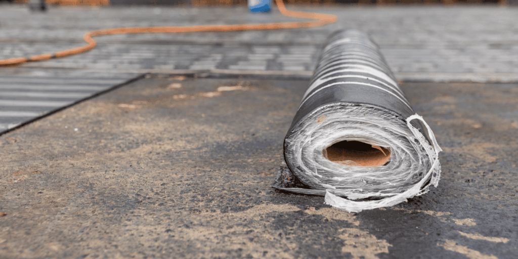 Close-up of roofing membrane roll used to fix a flat roof leak and improve waterproofing