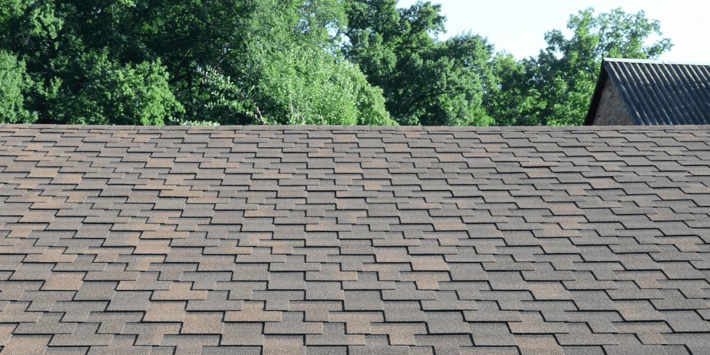 Close view of asphalt shingles after shingle roof cleaning, showing even pattern and well-maintained surface