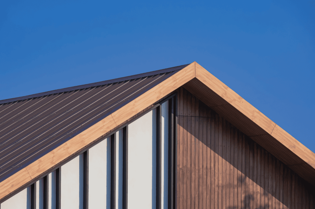 Close view of a clean, angled roof with metal roofing panels, built for strength, durability, and a modern look