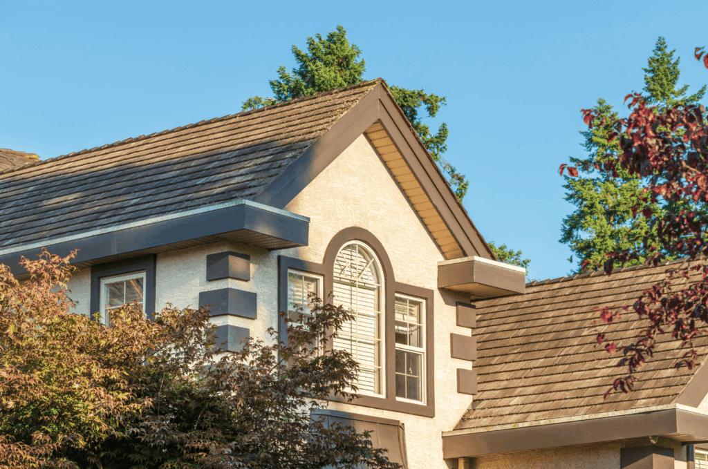 Beautiful residential home with a newly installed shingle roof after a complete roof replacement for long-term durability.