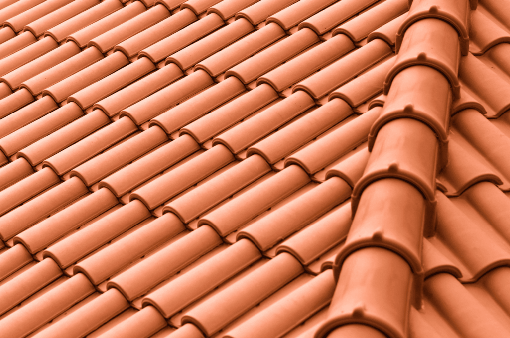 Angled view of tile roofing ridge with evenly placed tiles, helping protect the roof from rain and everyday weather