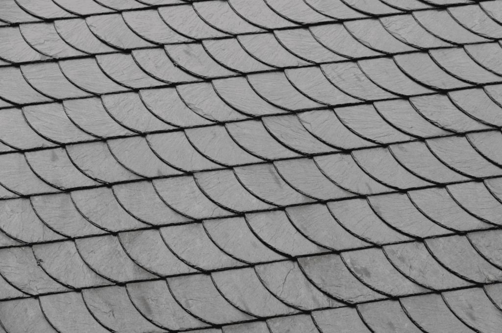 Light gray slate roofing pattern with curved tile edges, designed to provide reliable weather protection and classic style.