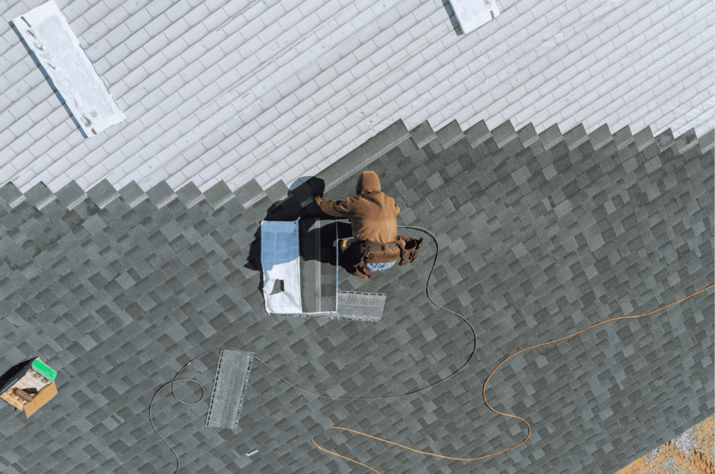 Roof replacement and roof overlay in progress as a contractor installs new shingles to strengthen the roof and extend lifespan