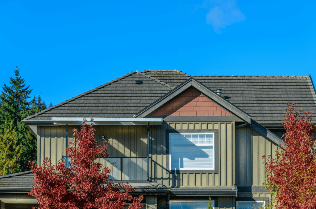  Residential home with asphalt shingle roof shown during a roof inspection to check for worn shingles and proper roof condition