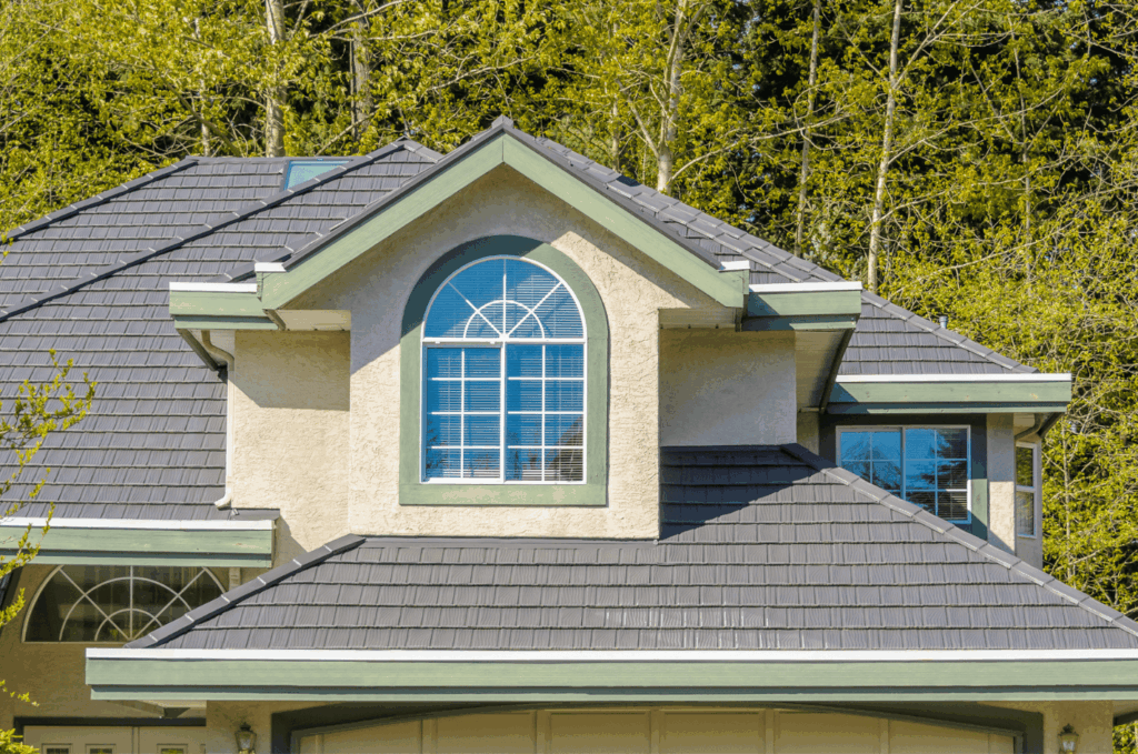 Dark tile roof with skylight viewed during a roof inspection to look for cracks, loose tiles, and possible leak areas