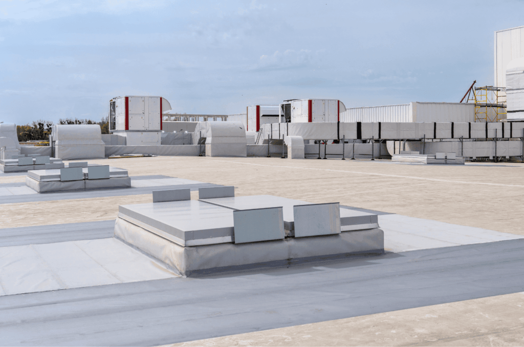 Flat commercial roof with vents and HVAC systems installed, showing a clean and sealed surface built for durability