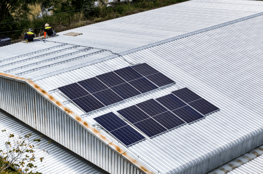 Metal commercial roof with solar panels installed, helping improve energy efficiency and support long-term building use