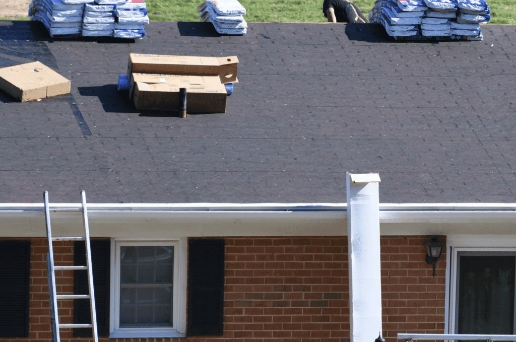 Roof installation in progress with roofing materials prepared on top of a home before shingles are added