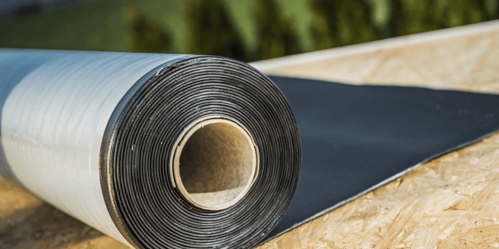 Close view of rolled roof underlayment material prepared for installation on a new residential roofing project