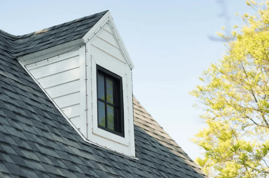 Dormer window with roof flashing installed around shingles to help protect the roof from leaks and water damage