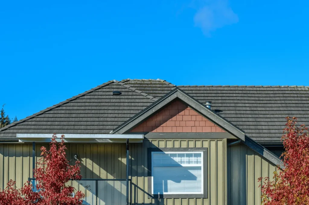 Residential roof with metal roof flashing installed along roof edges for added weather protection and durability