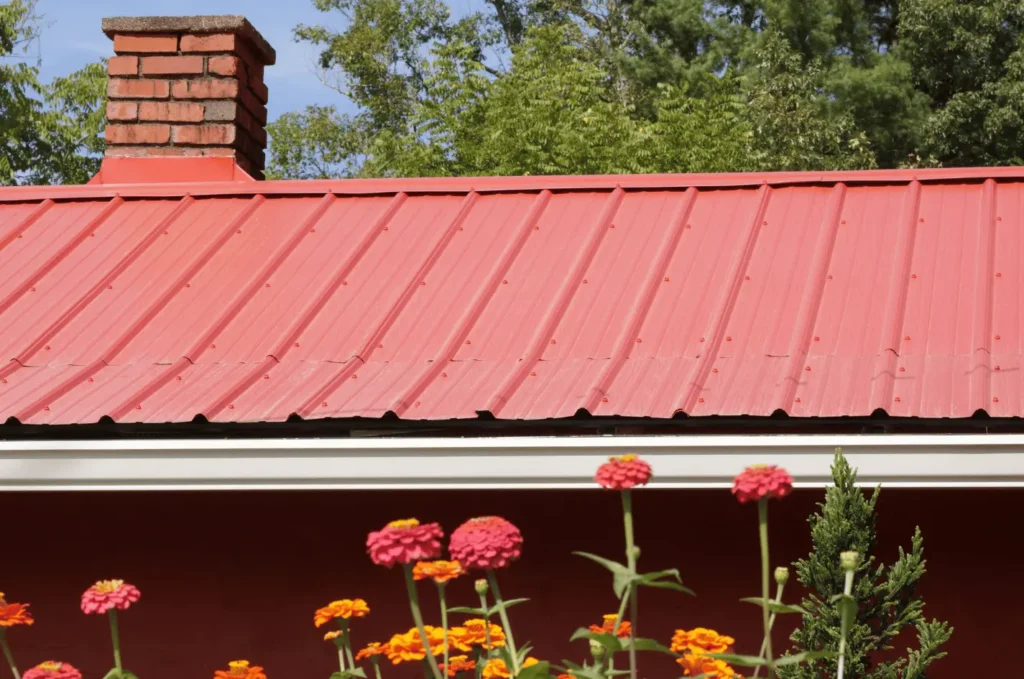 Close view of roof flashing and soffit installation beneath dark roof shingles on a residential home exterior