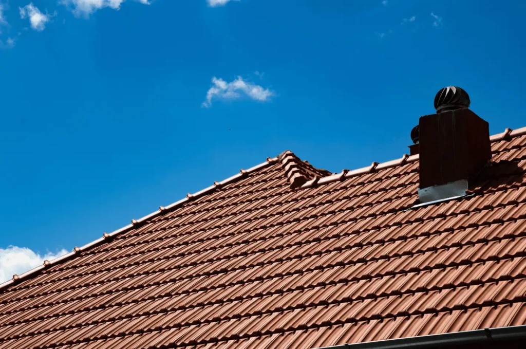 Clay tile roof with chimney and reinforced emergency roofing features designed for lasting weather protection