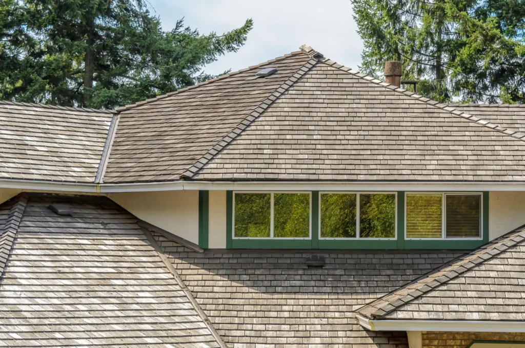 Large residential roof with multiple slopes and ridges, built to reduce the risk of an emergency roof leak