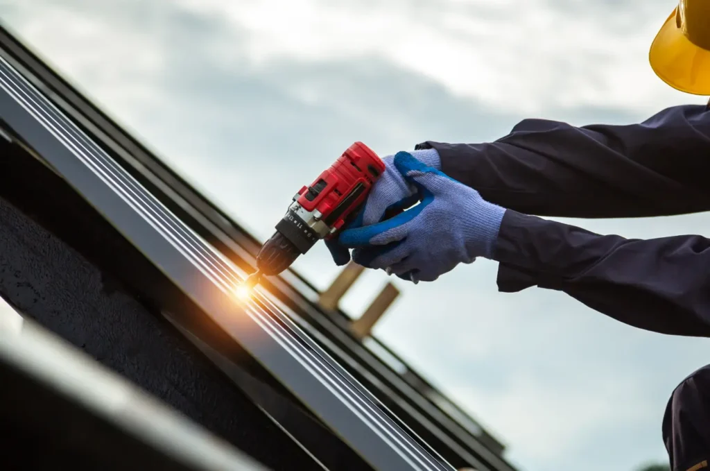 Worker securing roof edge materials during a roof damage repair to prevent leaks and strengthen vulnerable roof areas