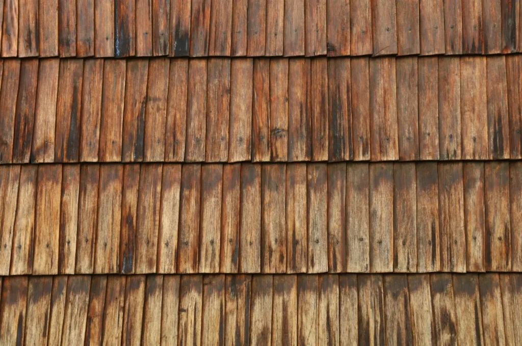 Weathered cedar shake roofing with layered wood shingles, offering natural beauty and reliable roof coverage