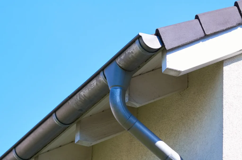 Water behind gutters causing damp areas around the fascia and edge of the roofing system
