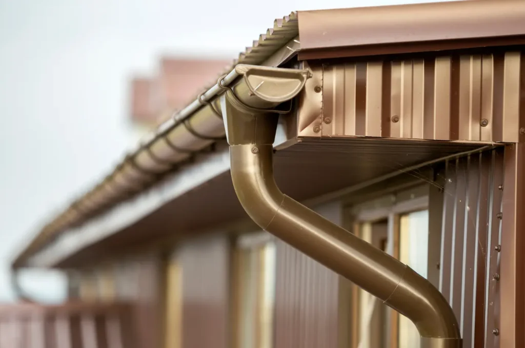 Copper gutters on a residential roof, designed to manage rainwater and protect the exterior