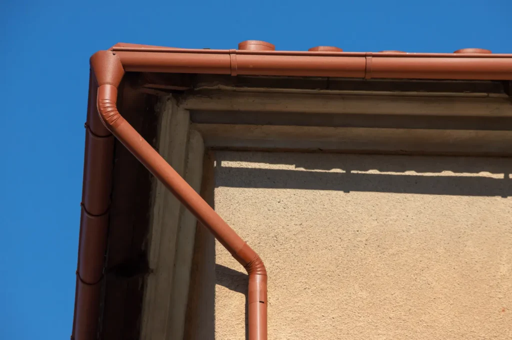 Copper gutters running along the roofline to direct rainwater away from the house 