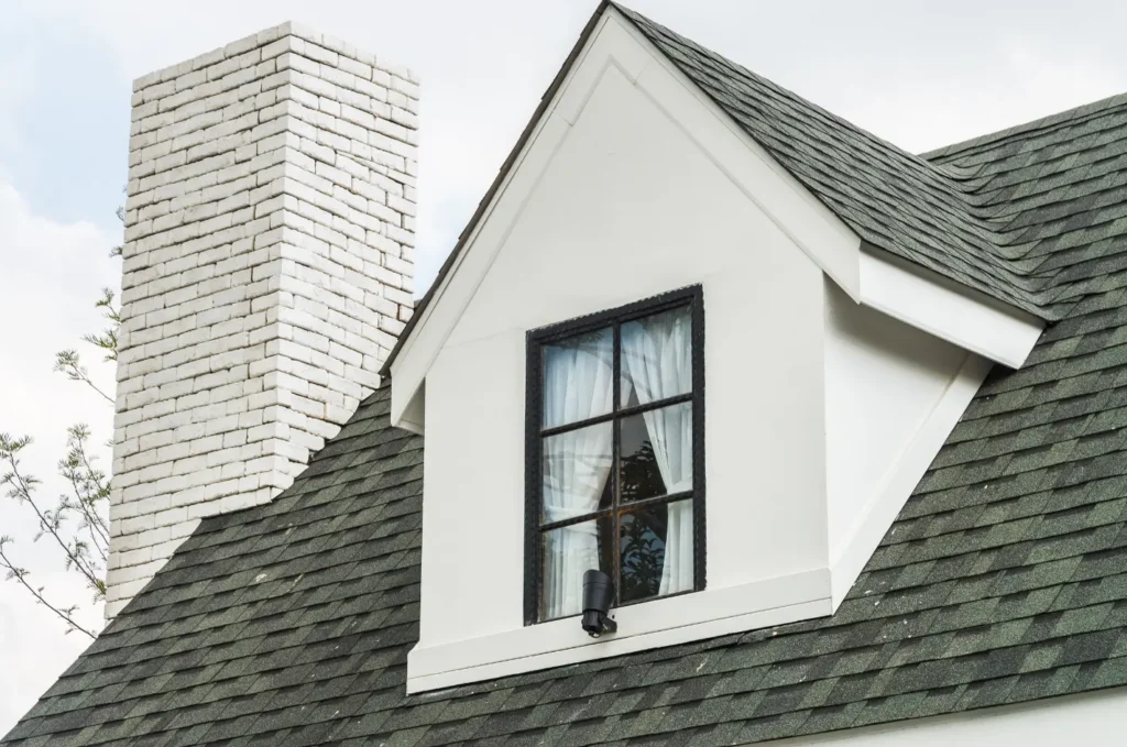 Asphalt shingles installed by licensed roofers across a sloped residential roof