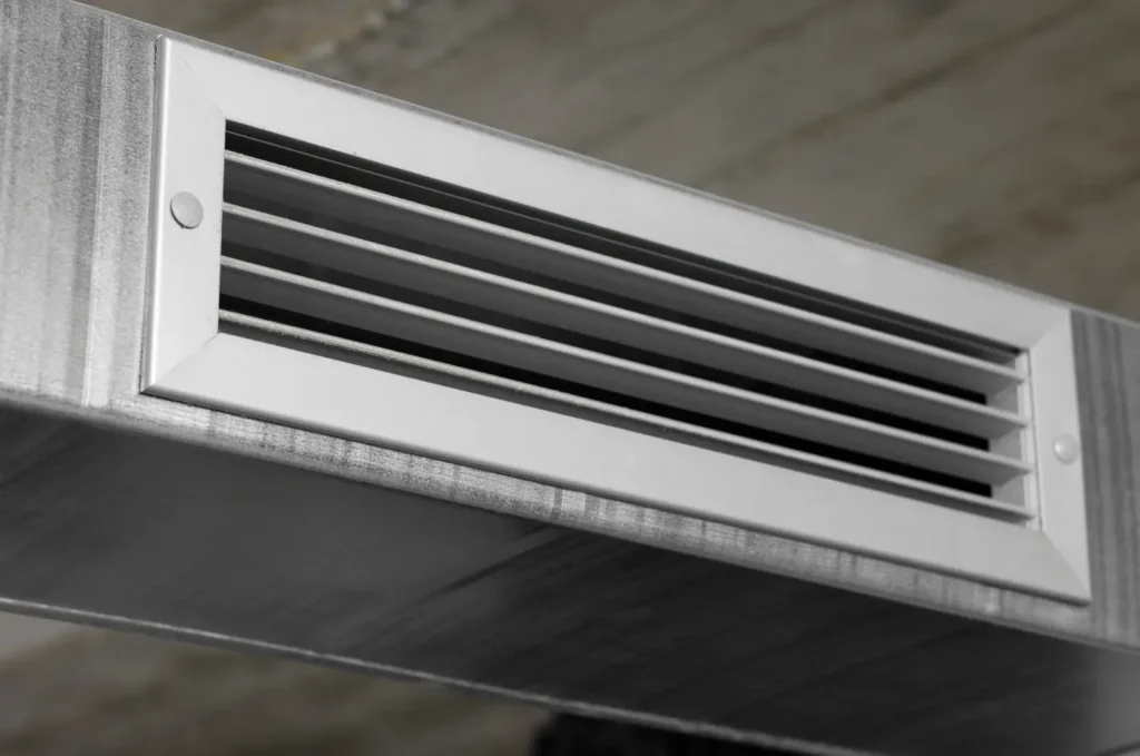 Soffit vent visible beneath the roof overhang along the edge of a commercial building