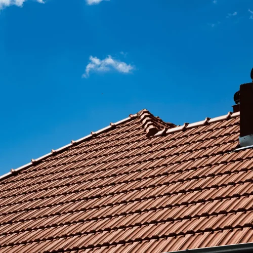 Clay tile roof with chimney and reinforced emergency roofing features designed for lasting weather protection